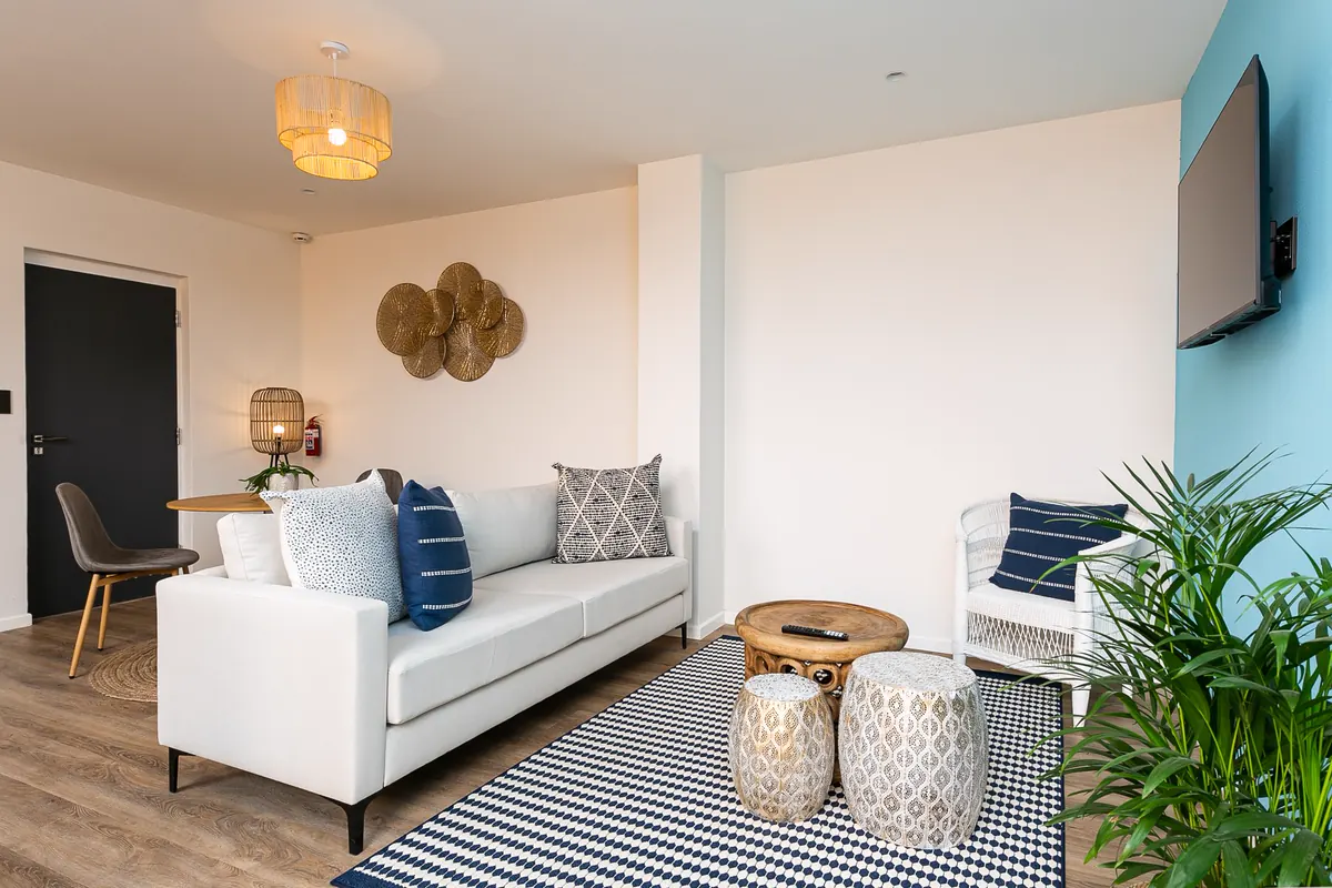 A boutique apartment lounge and kitchen at sunset