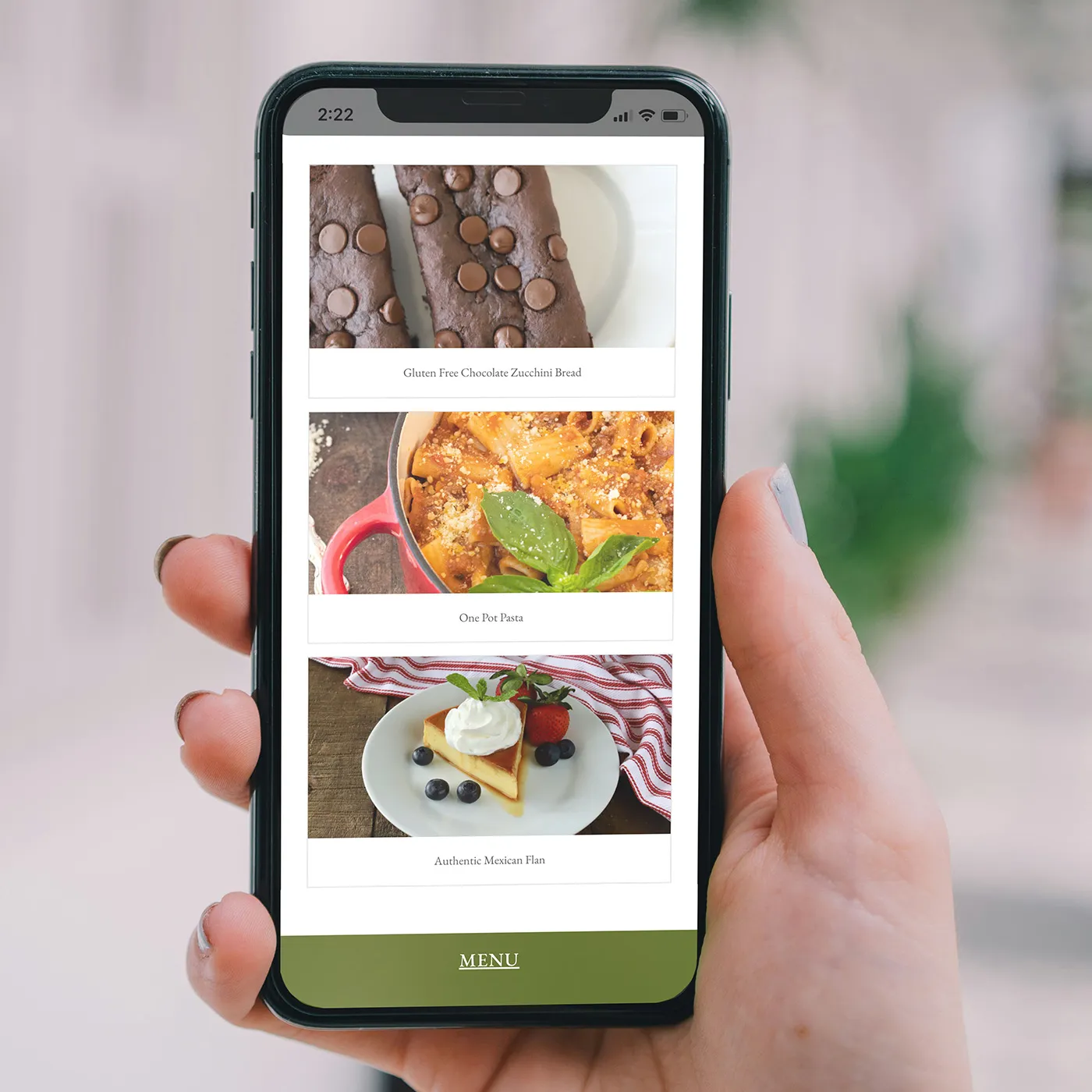 Marie Saba's recipes on a phone, held in one hand