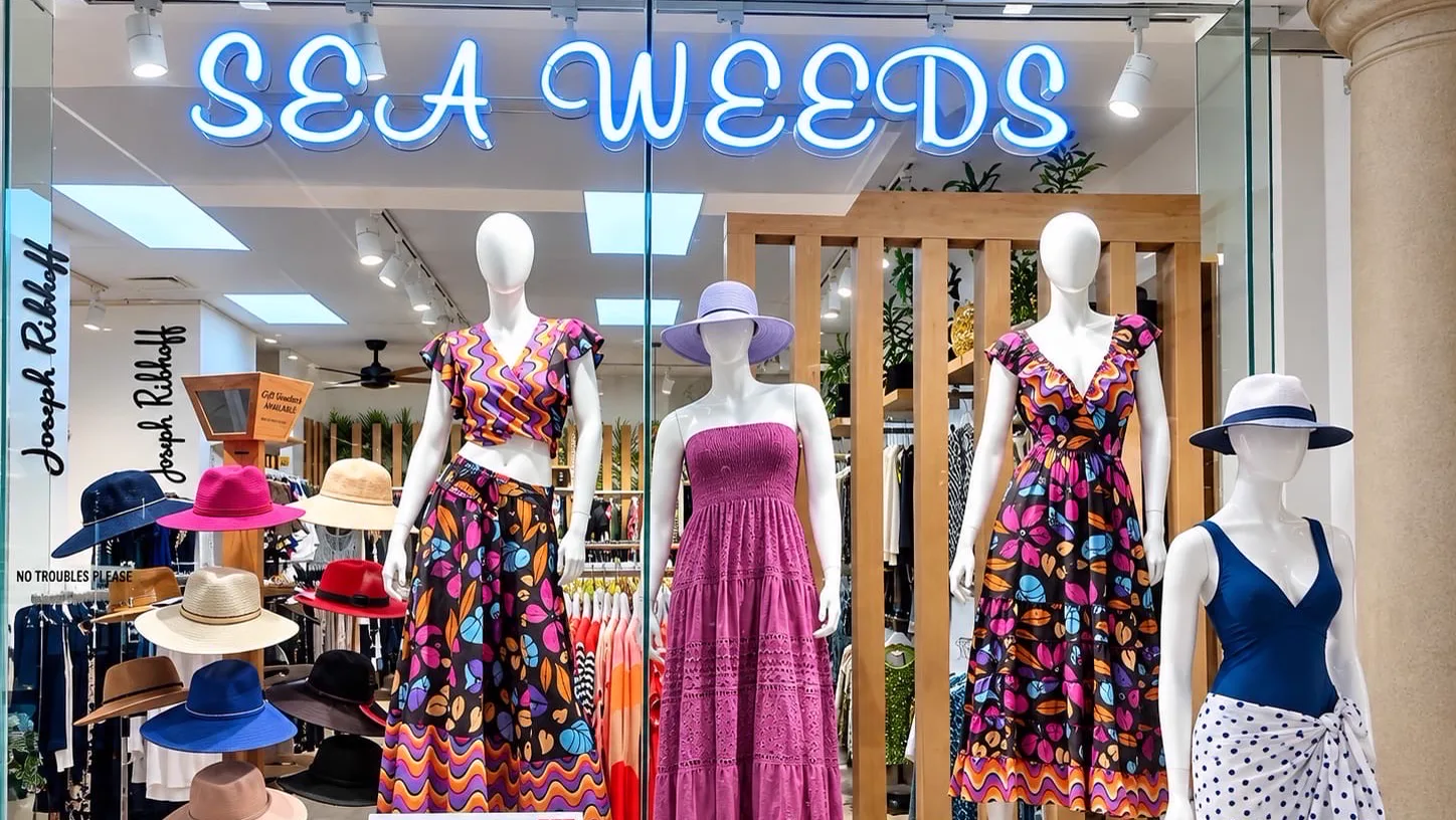 The Sea Weeds shop front in Constantia Village: summer dresses and sun hats in the window