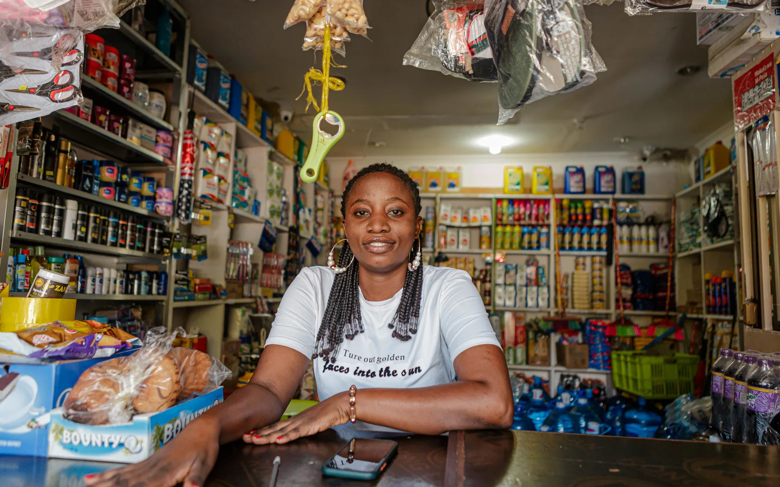 A shop owner behind the counter of her store: licensed stock, as used in the ads