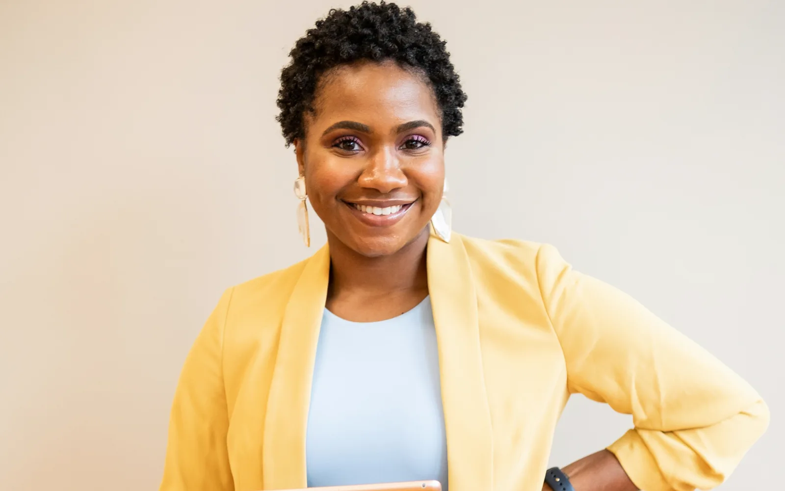 A smiling founder in a yellow blazer: licensed stock, as used in the ads